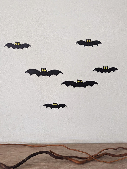 Cute bat wall decals with yellow eyes on a wall