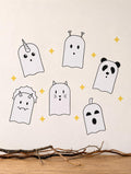 Six cute ghost wall decals on a cream wall